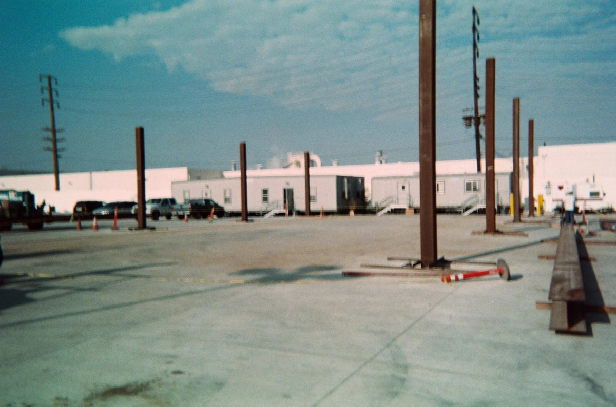 Archival construction photograph showing a row of canopy columns at a jobsite