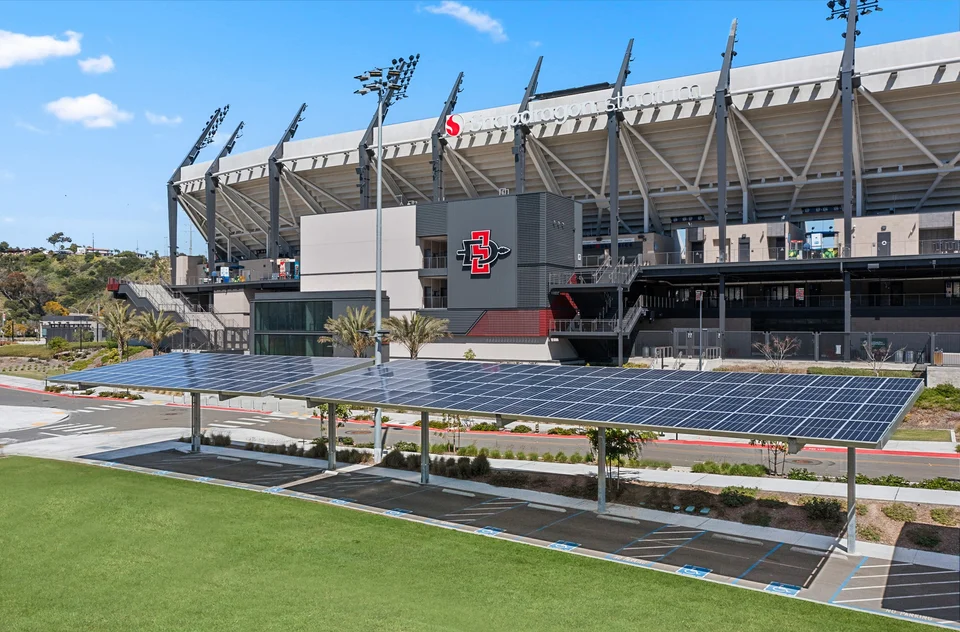 Solar panel rows over a stadium parking area
